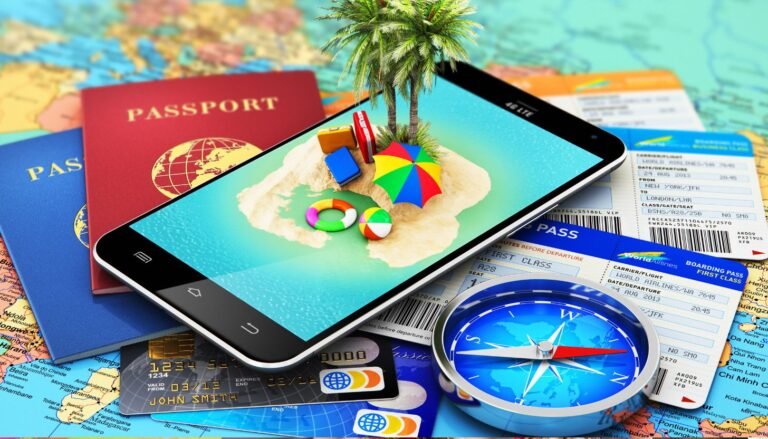 A smartphone showcasing an island with beach chairs and umbrellas rests on passports, boarding passes, and a compass. Nearby credit cards lie on a world map background, illustrating the fusion of travel technology and adventure.