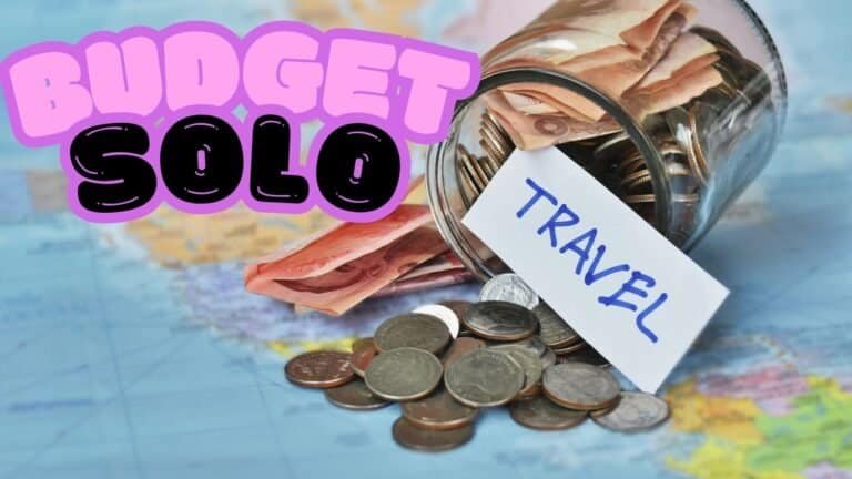 A jar labeled "TRAVEL" filled with banknotes and coins spills onto a world map, with the text "Budget Solo Travel Guide" in bold letters above. how to solo travel on a budget.